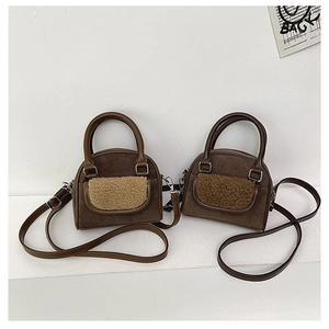 Detail of plush pocket on suede shoulder bags in dark and light brown tones