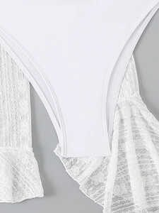 Close-up of white swimwear featuring delicate floral lace fabric and smooth stitching texture