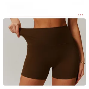 Detail of high-waist yoga shorts showing elastic waistband and coffee brown fabric texture