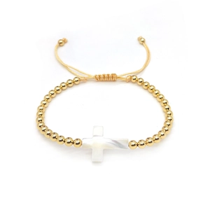 Beaded gold bracelet with shell cross pendant on adjustable cord for women