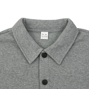 Close-up of the grey fleece jacket collar showing the black button and 100% polyester tag