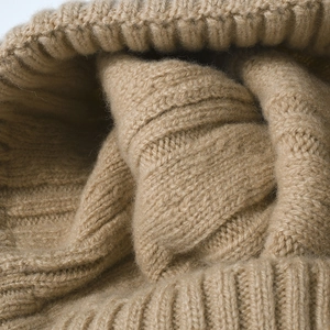 Chunky cable knit merino wool beanie in camel color with ribbed cuff for winter warmth