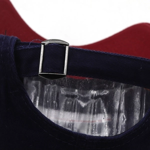 Detailed macro view of the adjustable navy blue back strap and silver metal buckle