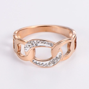 Macro view of rose gold hollow chain ring with white enamel and sparkling zircon pavé