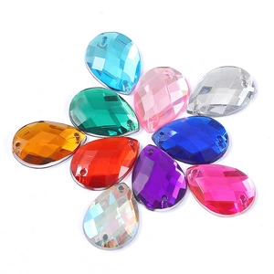 Macro detail of multi-color teardrop acrylic rhinestones with double sewing holes