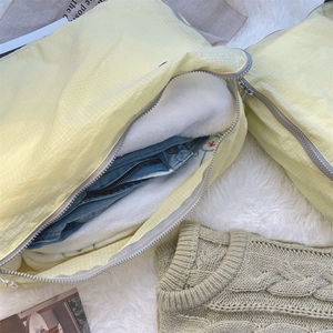 Close-up of lightweight yellow plaid travel packing cube with durable metal zipper