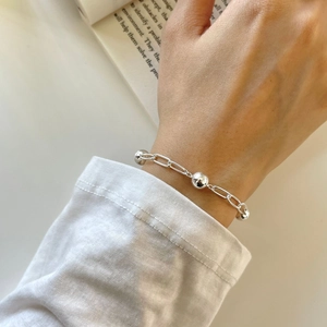 Minimalist 925 sterling silver beaded bracelet shown on a wrist with an elegant polished finish