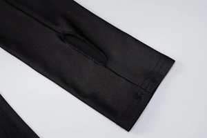 Detail of sleeve cuff with thumbhole design on black slim fit high neck mini dress