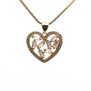 Golden heart pendant necklace with micro-inlaid cubic zirconia on a white background