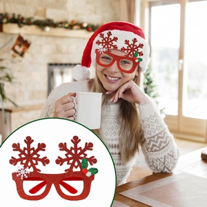 Close-up of glittery red Christmas glasses with snowflakes and holly leaf details