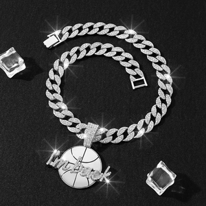 Detail of silver Cuban chain and round pendant with iced-out I'm back text and basketball