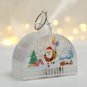 Close-up of LED Christmas lantern with Santa Claus illustration and festive lights