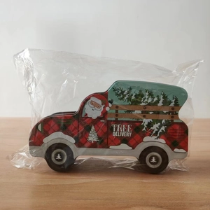 Detail of a Christmas car candy tin box featuring festive tree delivery patterns