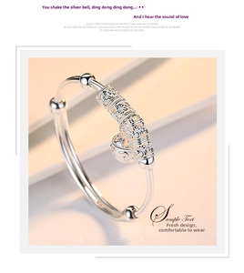 Detail of silver-plated bell bracelet with intricate hollow carving for kids