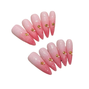 Pink gradient press-on nails with golden stars, tiny pearls and cat-eye texture finish