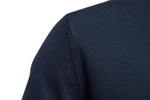 Close-up of high-quality navy blue knit fabric showing fine stitching and texture detail