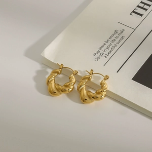 Elegant 18k gold plated twisted hoop earrings for women on minimalist white background