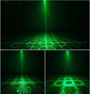 Detail view of green laser stage light projecting grid, circle, and star patterns