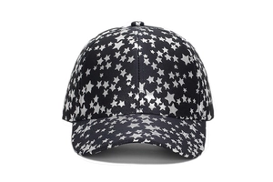 Detail of black baseball cap with grey star prints and classic six-panel stitching