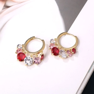 Golden hoop earrings with dangling colorful gemstones and red pendant charms