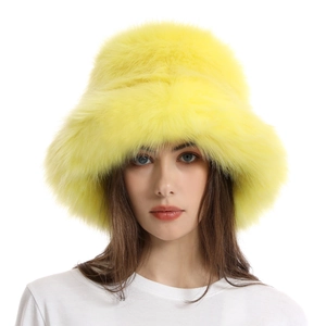 Detailed texture of thick bright yellow faux fur on a warm winter bucket hat for women
