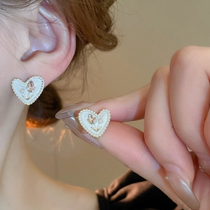 Elegant vintage heart stud earrings with pearls and tulip crystal inlay on ear