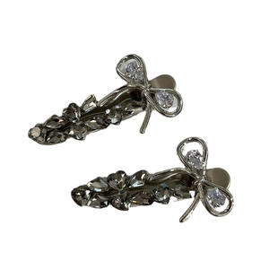 Elegant silver metal bow hair clips with dark grey rhinestones and sparkling crystal center