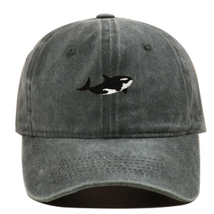 Detailed embroidery of an orca whale on a vintage washed cotton baseball cap texture