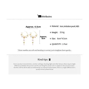 Detailed size and weight specs for gold C-shaped earrings with faux pearl tassels