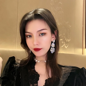 Luxurious silver drop earrings with square faux crystals worn by a fashion model