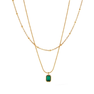 Detail of 18k gold double-layered necklace featuring an emerald-cut green zircon pendant