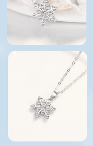Detailed close-up of a silver snowflake pendant necklace encrusted with white zircon stones