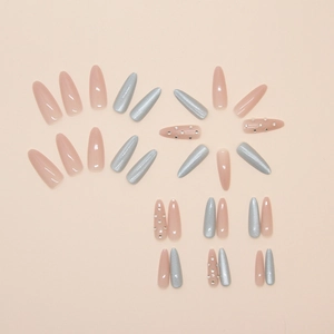 Detail of almond cat eye press-on nails with pink glitter and rhinestone accents