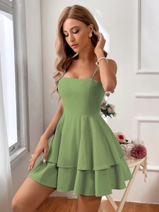 Detailed view of the sage green tiered mini dress with spaghetti straps and high waist