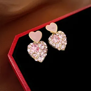 Exquisite gold-plated pink rhinestone heart earrings presented in a luxury jewelry gift box