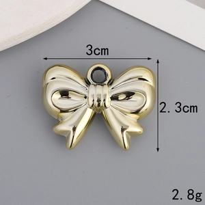 Gold bow-shaped charm detail showing dimensions 3cm x 2.3cm and 2.8g weight