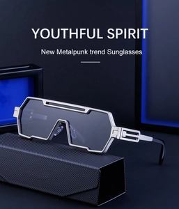 Detail of futuristic silver metal sunglasses with hollow geometric lines and case