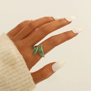 Close-up of adjustable leaf ring with green enamel inlay worn on model's finger