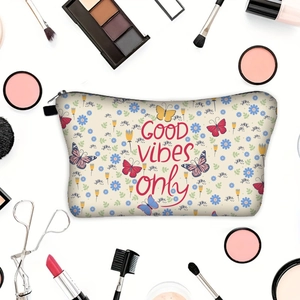 Flat lay of butterfly print makeup bag with GOOD vibes only text and cosmetics