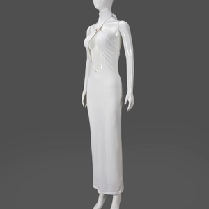 Detail of white cutout halter maxi dress featuring metal accents and bodycon fit