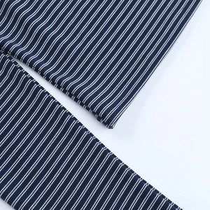 Detailed close-up of blue and white striped knit fabric texture with fine stitching