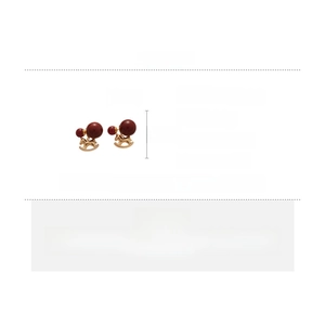 Macro detail of red bead earrings with gold horse pendant, dimensions 2.2cm by 1.2cm