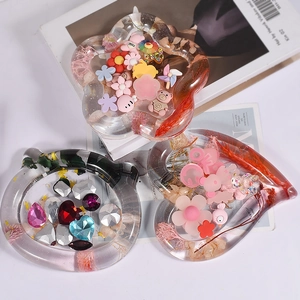 Detailed close-up of DIY resin trays in flower, cat, and heart shapes with dried flowers
