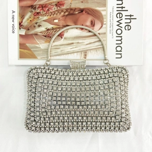 Detail of silver rhinestone evening bag with round crystals and metallic handle