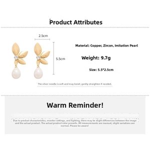 Detail of gold leaf drop earrings with sparkling zircon and white teardrop pearls