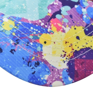 Macro view of cotton baseball cap brim with colorful abstract graffiti and stitching