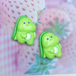 Close-up of cute green resin dinosaur charms for DIY hair clips and phone cases