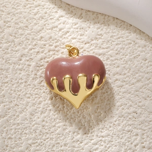 Detail of pink enamel heart pendant with melting gold metal finish and top ring