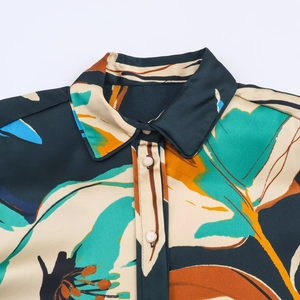 Women casual floral print shirt with abstract green and orange pattern on white background