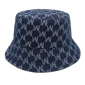 Detailed view of dark blue denim bucket hat with monogram jacquard pattern and flat top